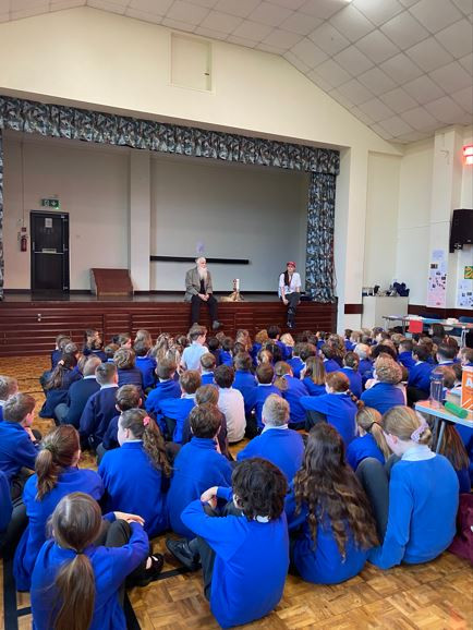 school sitting in assembly